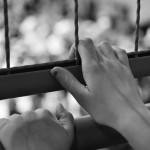 Detainers-hands-on-fence-150x150.jpg