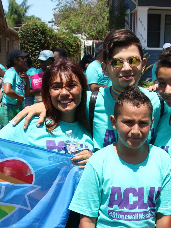 Five young people in ACLU teal shirts posing for a picture.