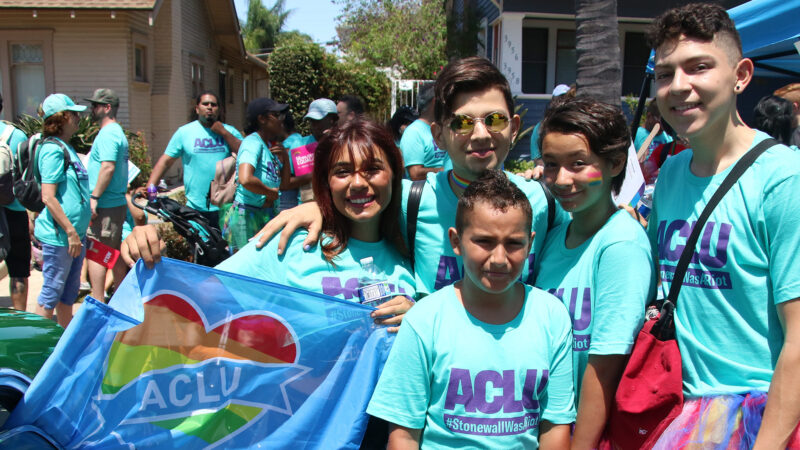 Five young people in ACLU teal shirts posing for a picture.