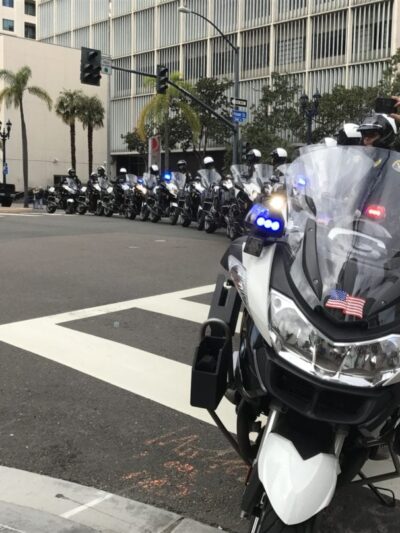 San Diego Police Department motorcycles and their riders forming a line to block traffic.