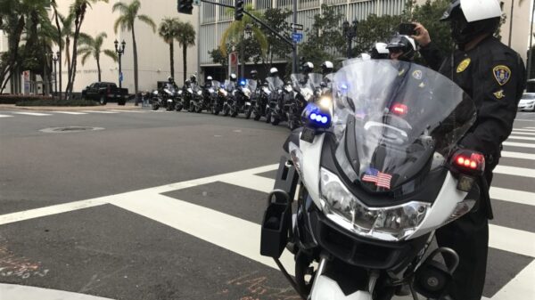 San Diego Police Department motorcycles and their riders forming a line to block traffic.