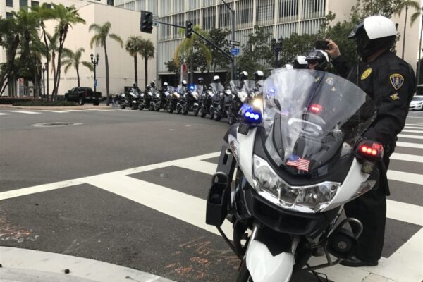 San Diego Police Department motorcycles and their riders forming a line to block traffic.