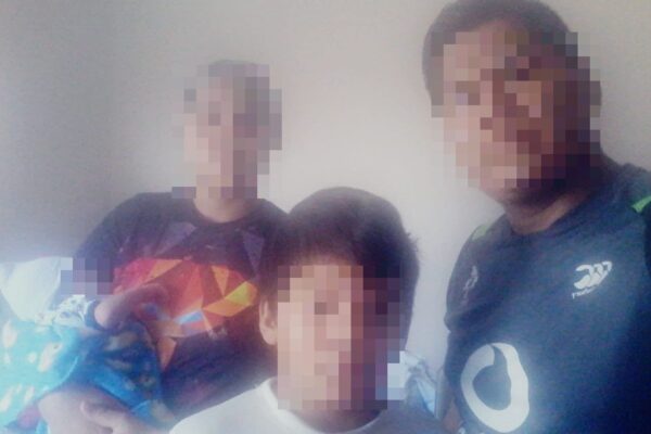 Image of a family with pixelated faces to protect their identity.