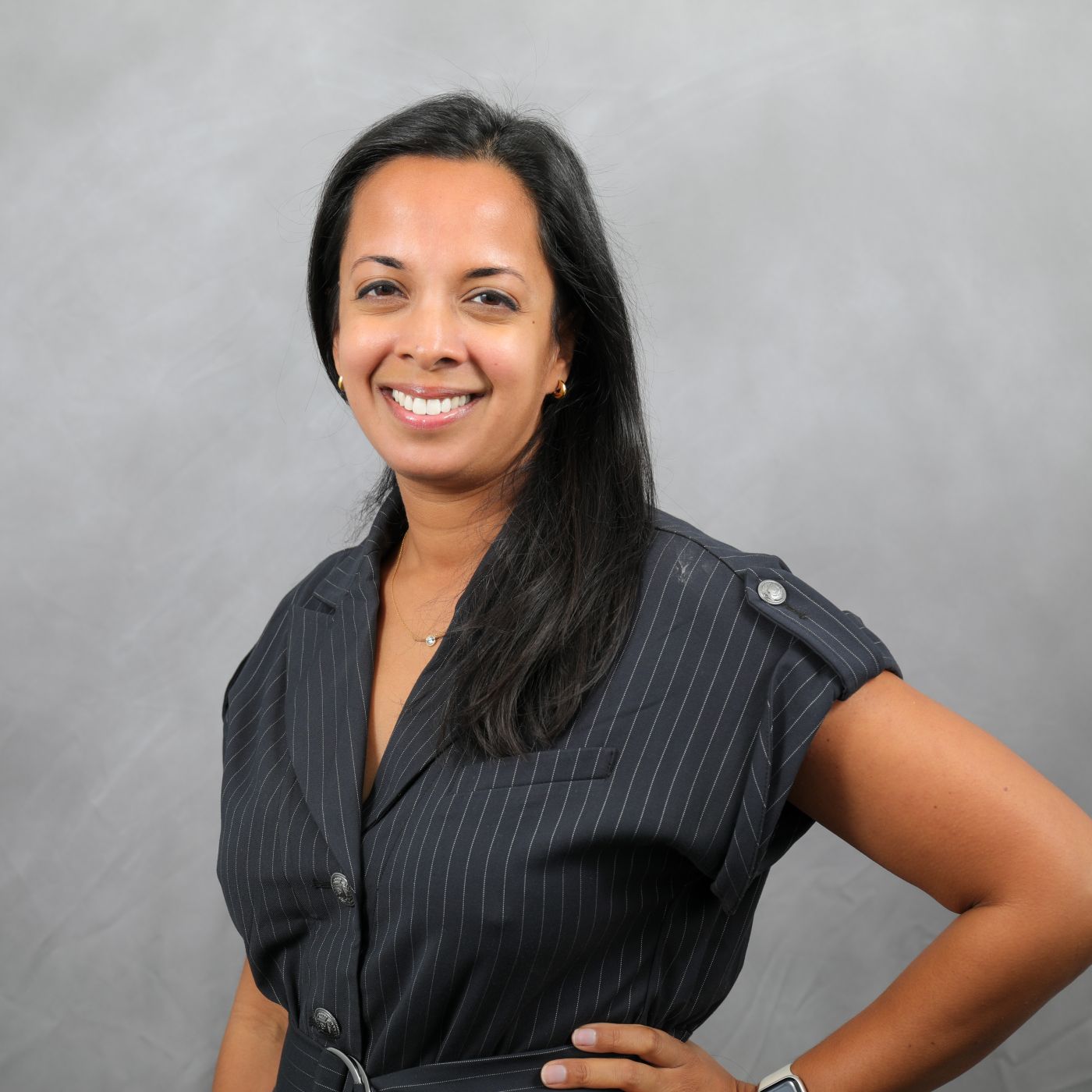 Photo of Nalini smiling at the camera.