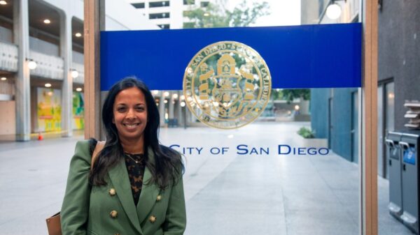 Nalini stands in front of City of San Diego emblem
