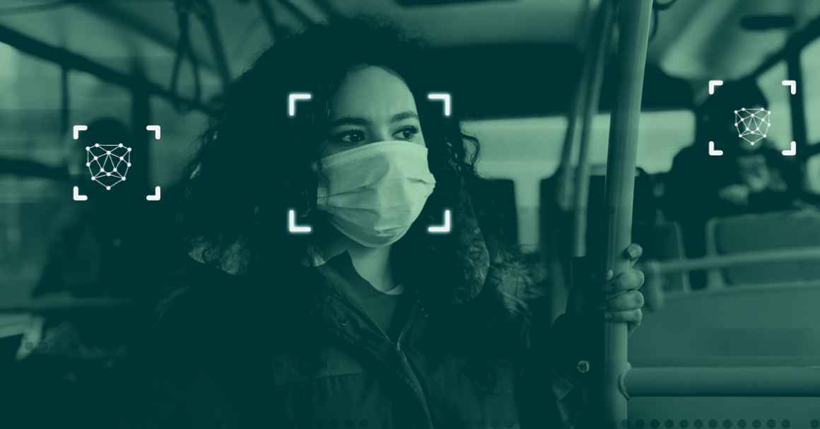 A person with a facemask on a bus with two others in the back. Each seem to be digitally tracked by facial recognition techonolgy that reads points on their face.